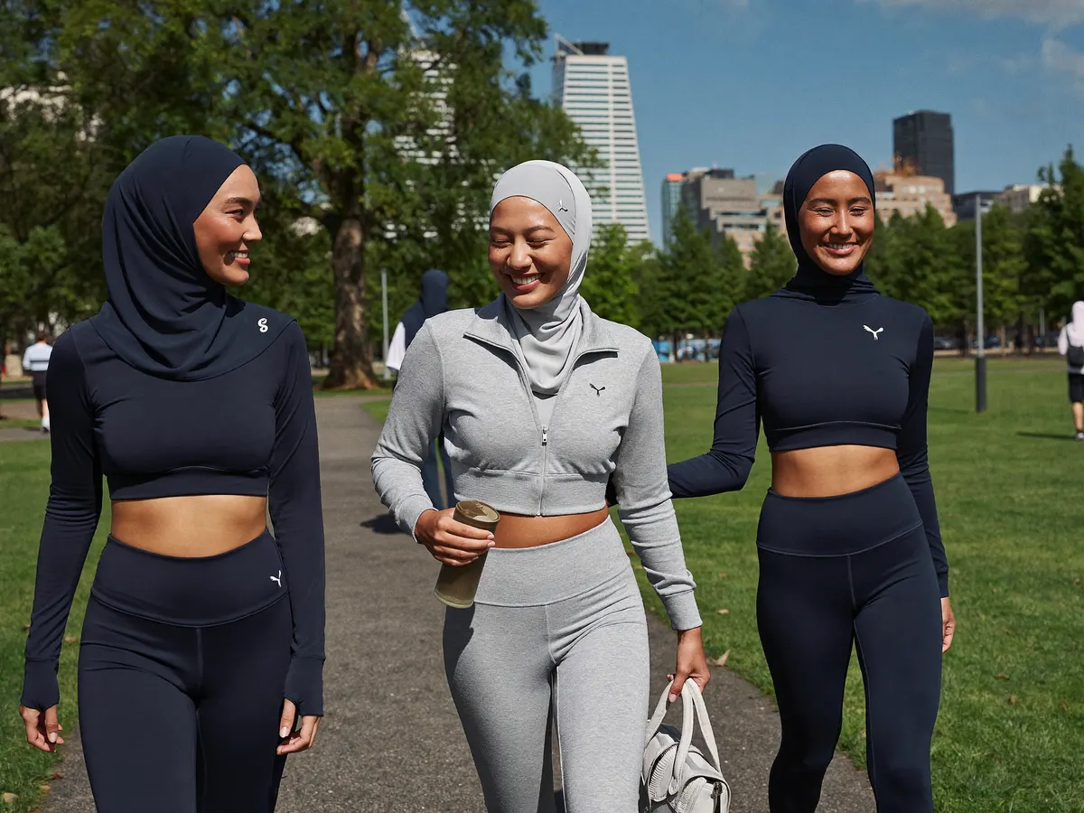 Friends in coordinated Malay activewear walking together after training
